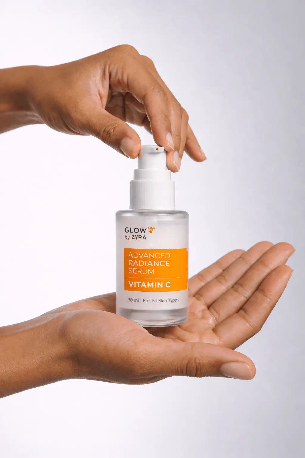 Glow Recipe Advanced Radiance Serum with Vitamin C held in a hand against a white background