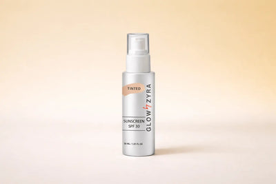 Glow Zyra sunscreen spray bottle on a beige background